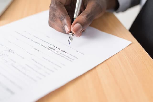 A person signing an NDA agreement. 
